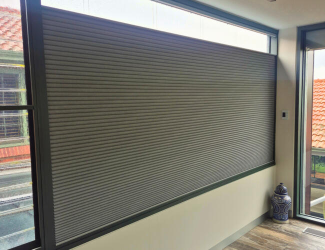 A top-down bottom-up blind on a large window in a soft grey blue colour