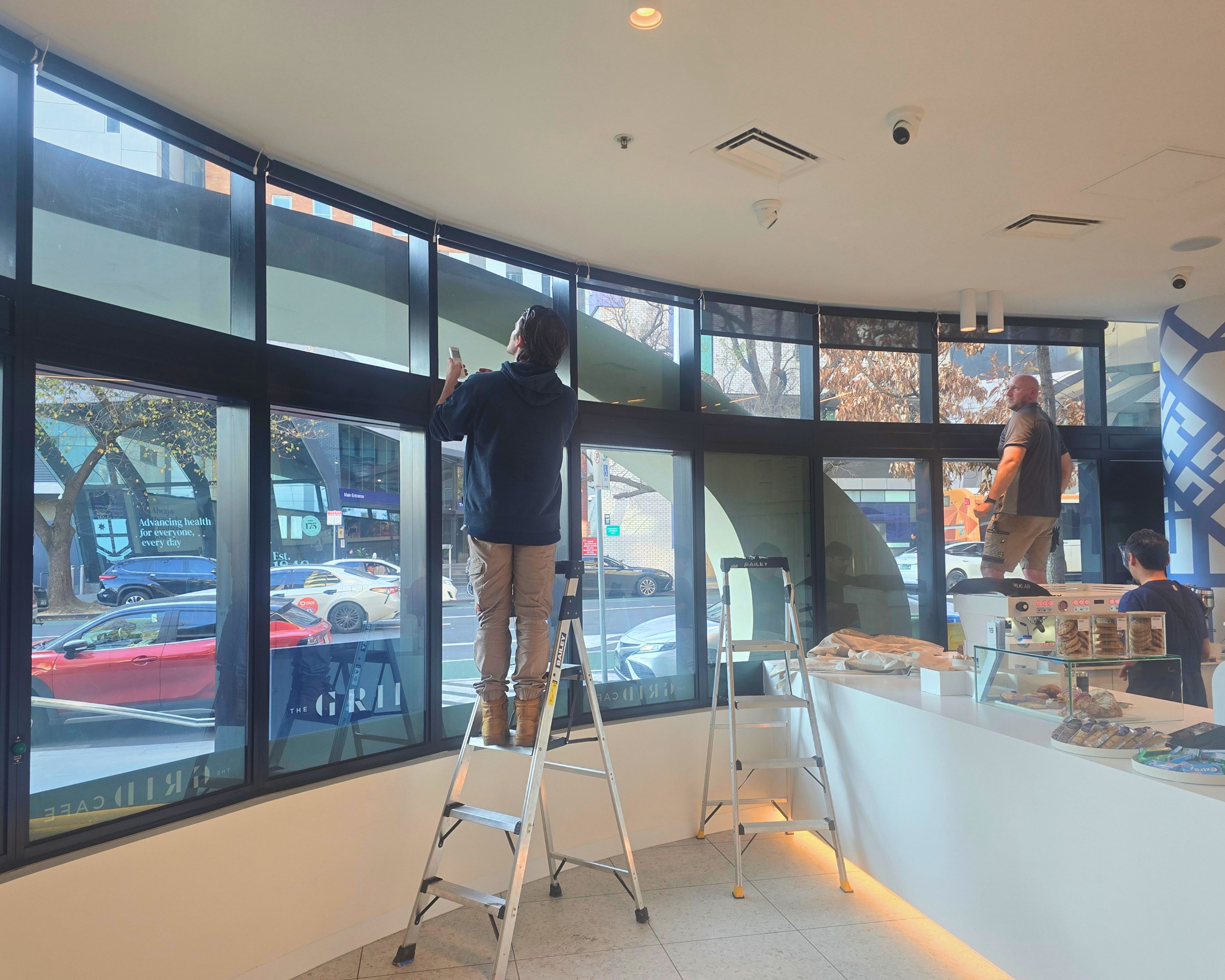 Battery automated roller blinds for a café in Parkville installed by Fabric Creations