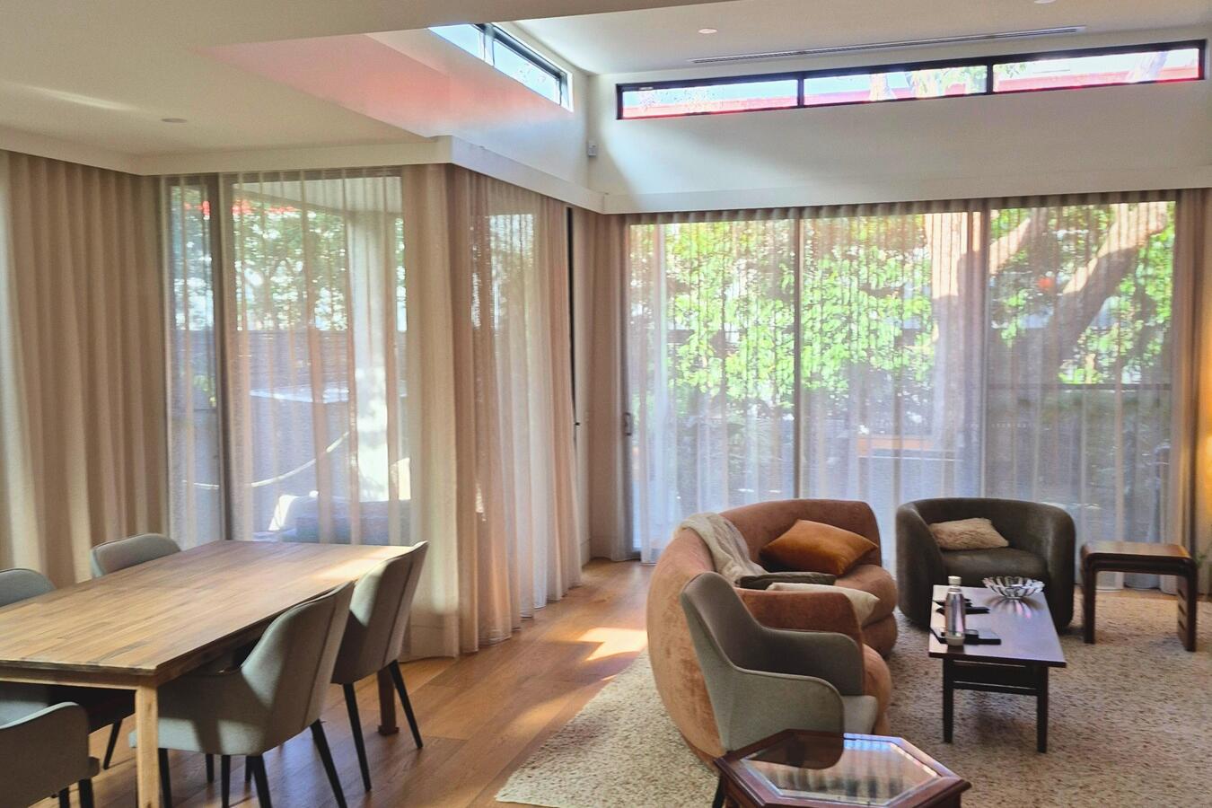 Living room in Beaumaris with warm neutral sheer curtains