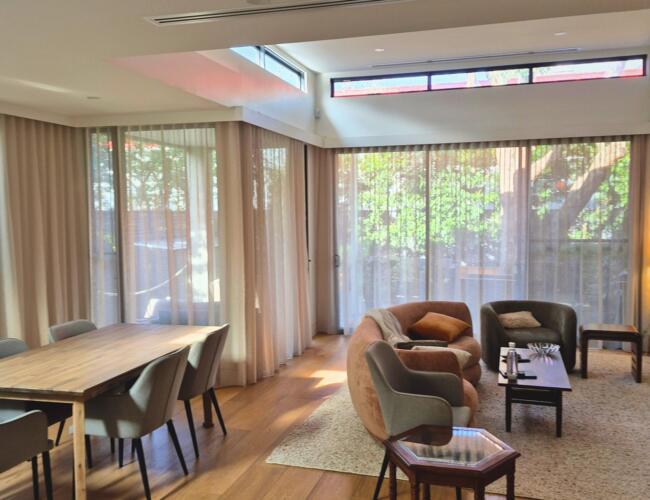 Living room in Beaumaris with warm neutral sheer curtains