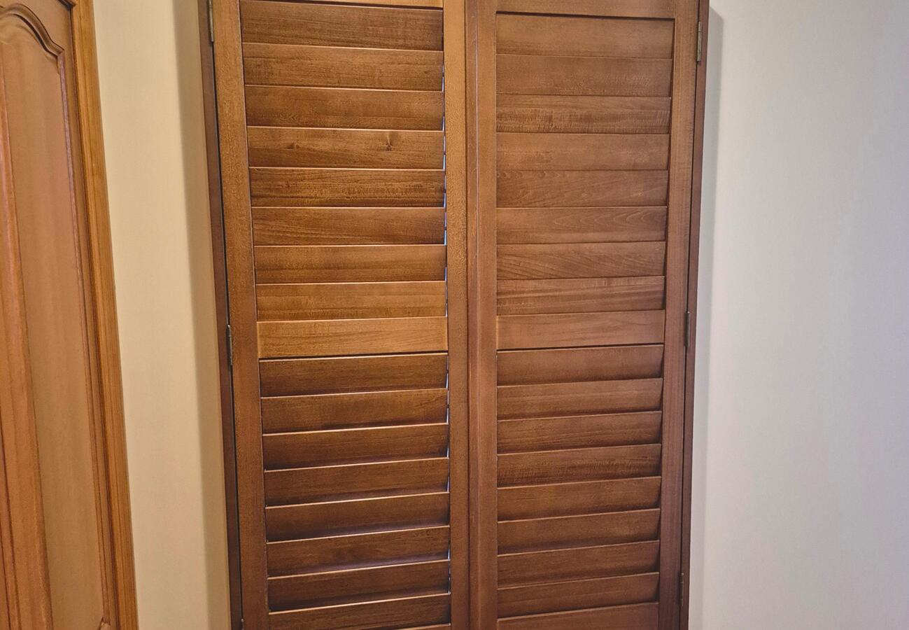 Natural wooden shutter installed by Fabric Creations