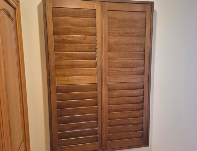 Natural wooden shutter installed by Fabric Creations