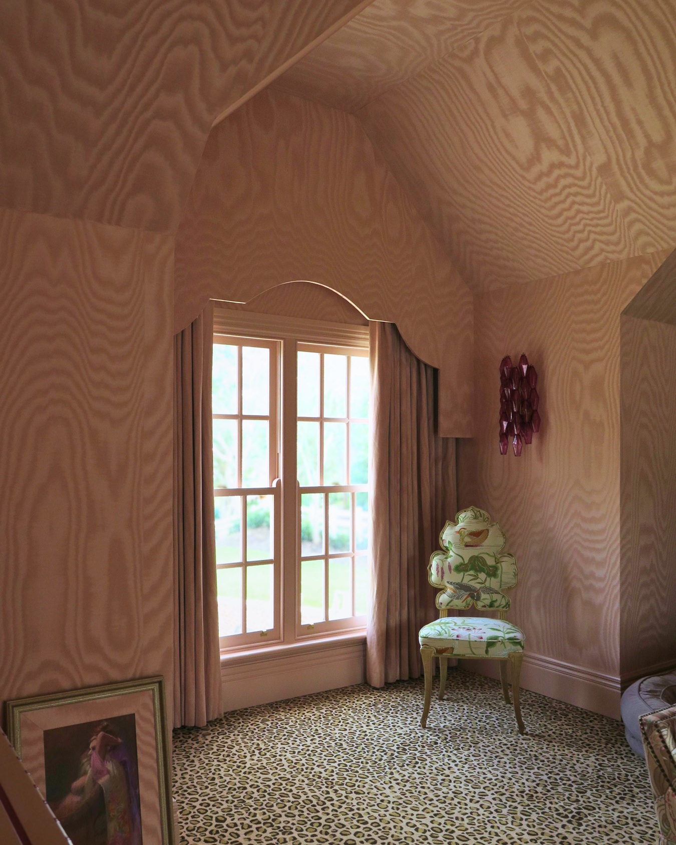 A first class example of pattern matching and pattern clashing - mixing pink moiré wallpaper and curtains with leopard print carpeting