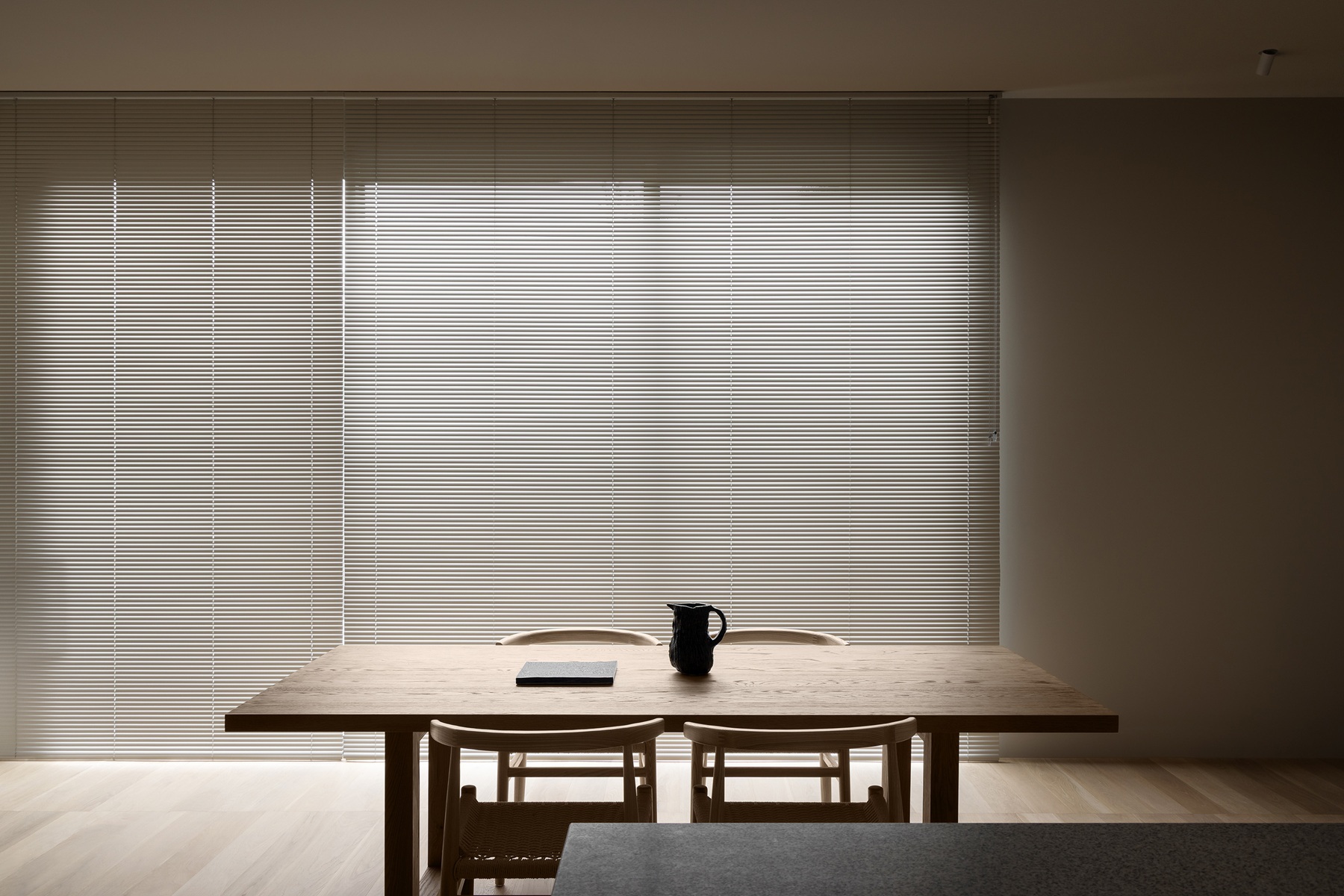 An architecturally designed space, featuring perforated aluminium Venetian  blinds installed by Fabric Creations