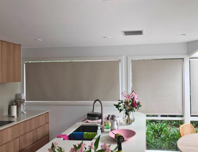 Kitchen in Beaumaris with roller blinds for light control and privacy installed by Fabric Creations